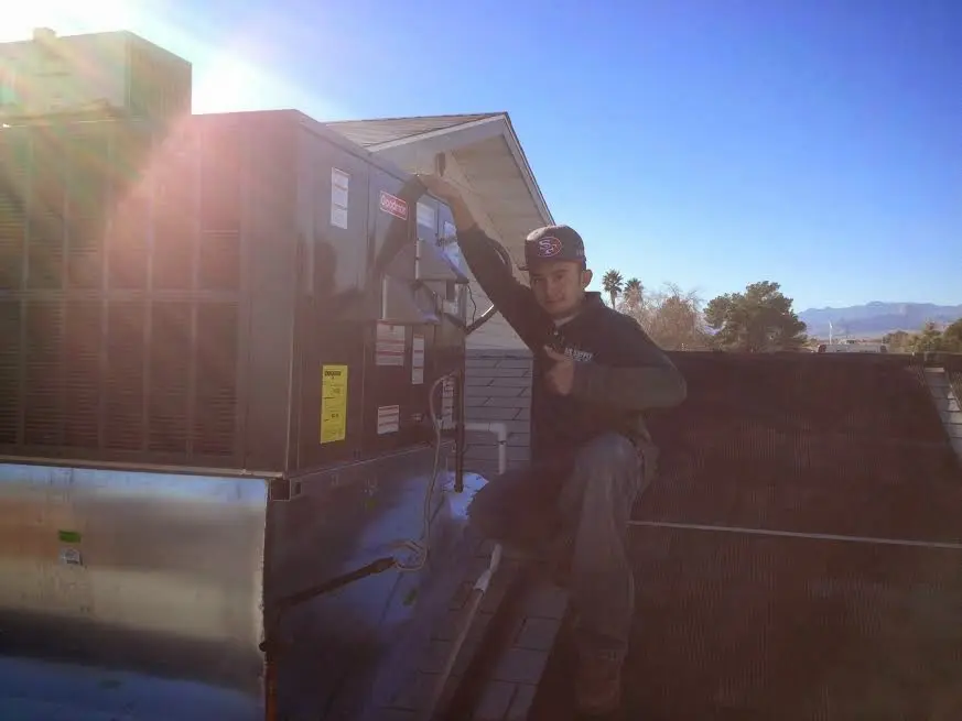 HVAC technician performing Air Duct Repair on a rooftop unit in Grandview Heights